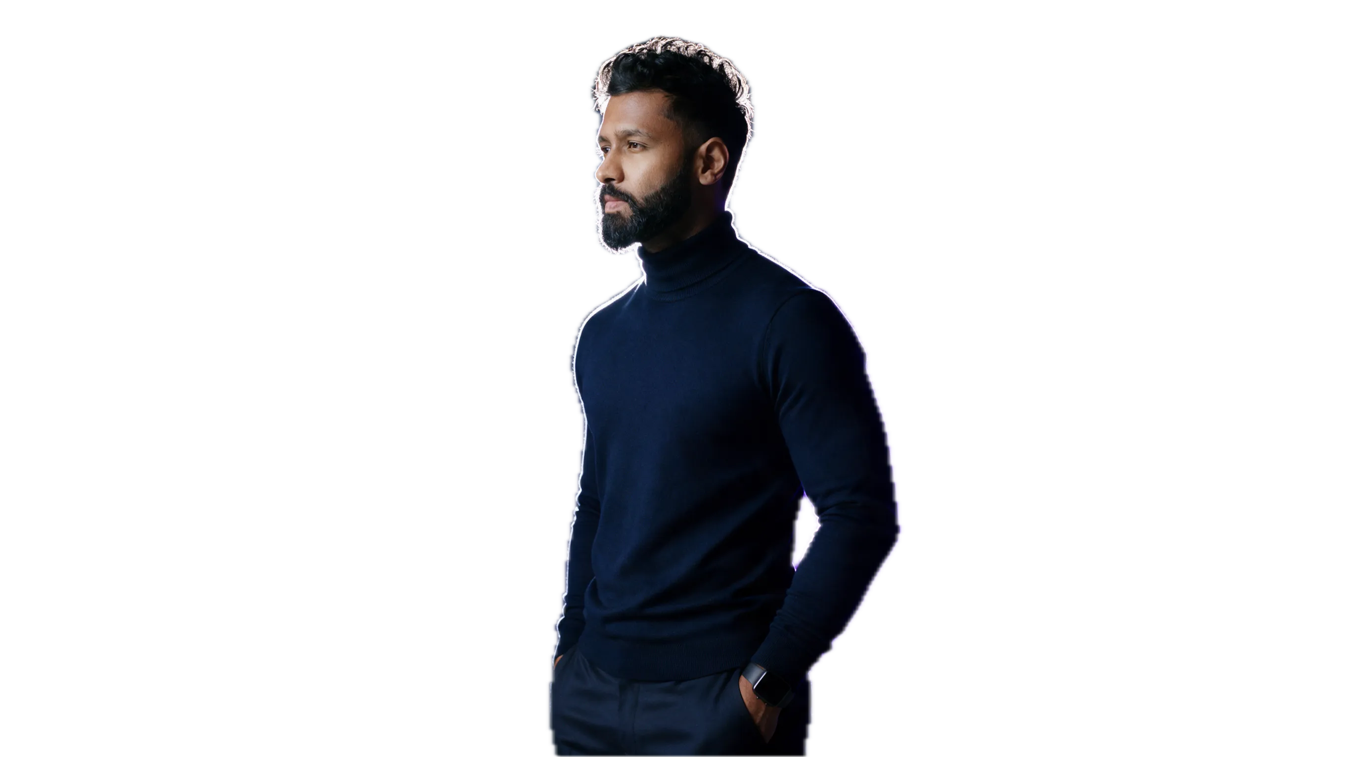 Sam Lingaraju in a navy turtleneck, lit by violet studio light